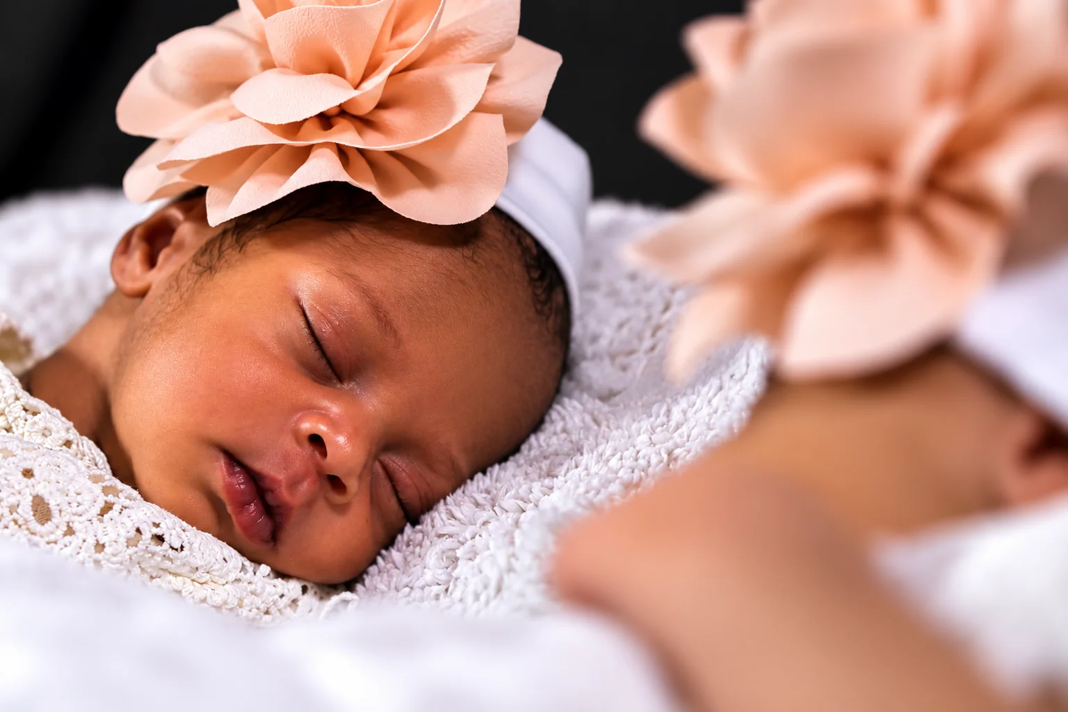 Close newborn portrait with a floral headband